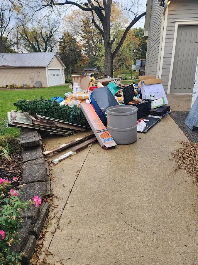 Dumpster being loaded with debris for 3 Yard Dumpster Rental in Bethel